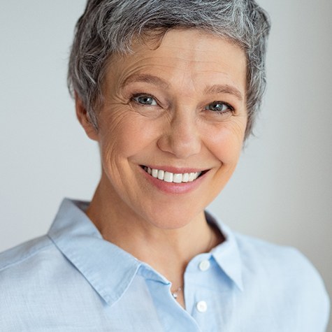 Smiling woman with All-On-6 dental implants