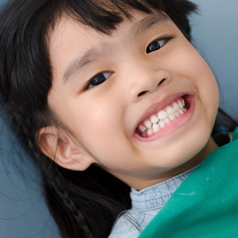 Child smiling in dental office