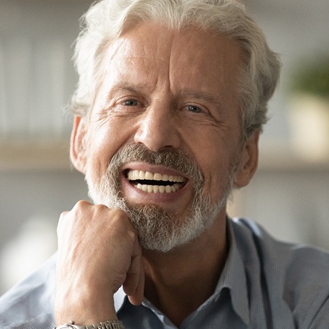 Elderly man with a wide smile looking at the camera
