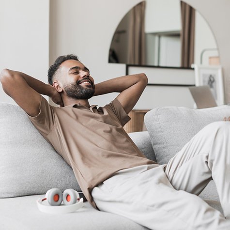 Man reclining on sofa relaxing at home