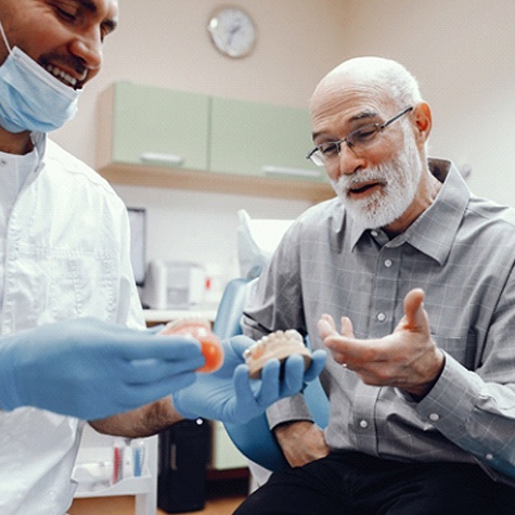 A dentist talking with an older gentleman