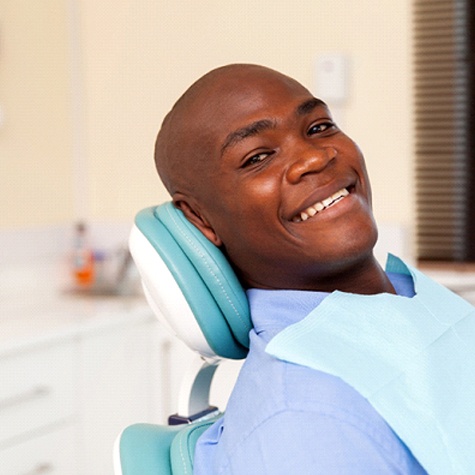 A young man sitting and waiting to see his dentist for a regular checkup