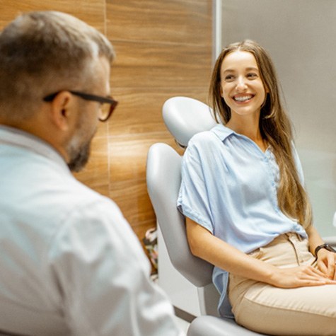 a patient smiling and talking to a dentist