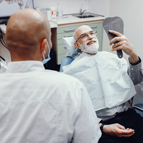 An elderly man receiving a dental checkup