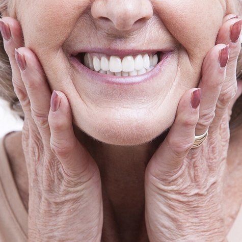 An up-close look at an older woman’s smile, complete with new dentures