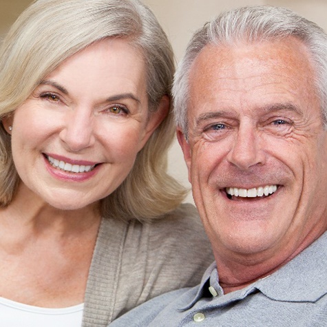 Couple smiling after receiving their new dentures in Doylestown