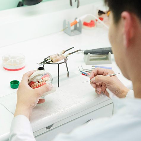 A lab technician creating a set of dentures