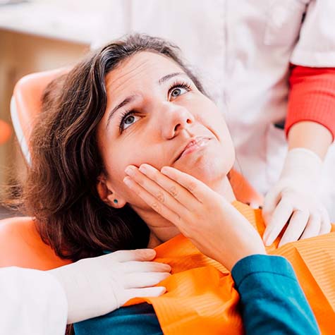 Pained woman visiting her dentist