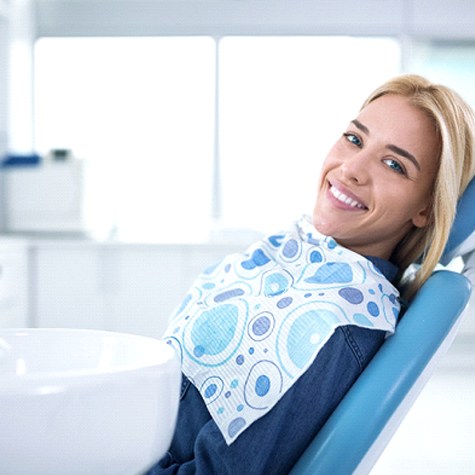 Female dental patient waiting in dentist’s chair