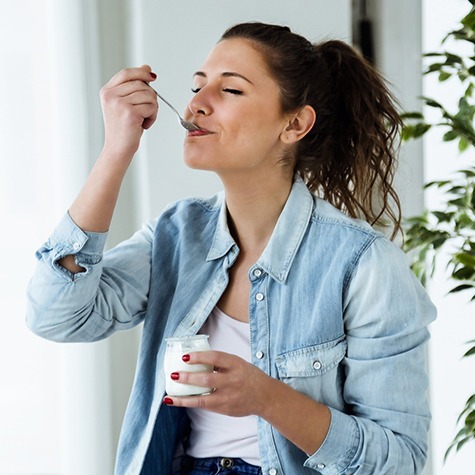 Woman enjoying a serving of white yogurt