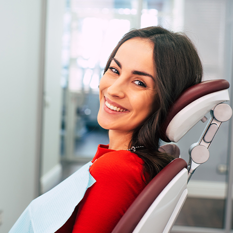 Woman smiling after receiving one visit dental restoration
