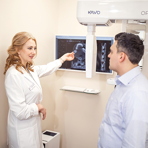Doctor Kandov showing patient 3 D C T cone beam images