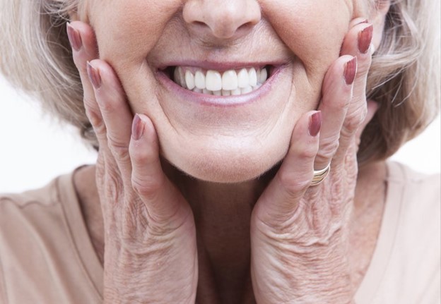 person with dentures smiling